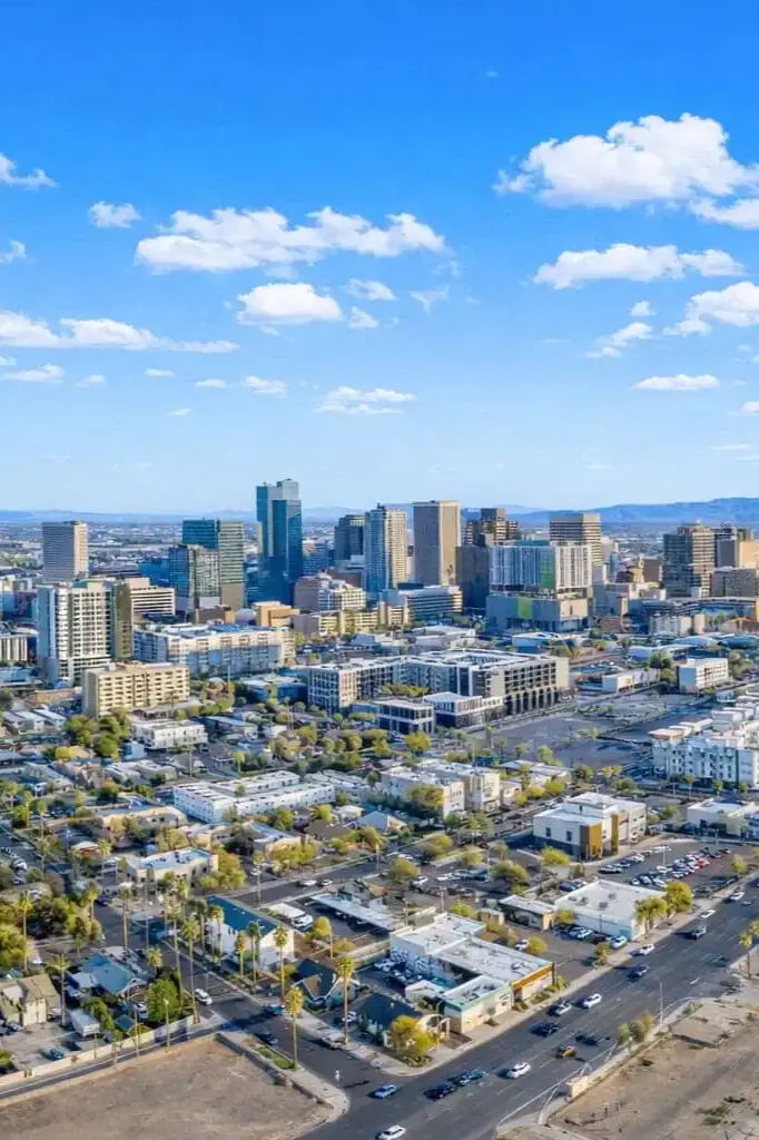 A city skyline with modern buildings and clear blue sky.
